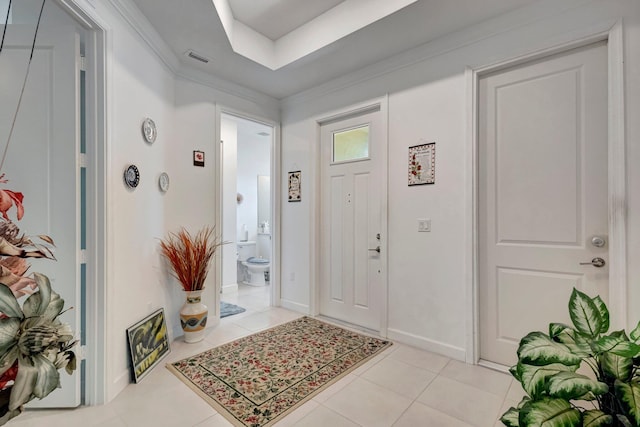 556 SE Mulberry Way, Port Saint Lucie, FL 34984 - foyer featuring light tile patterned floors, crown molding, and a tray ceiling