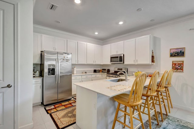 556 SE Mulberry Way, Port Saint Lucie, FL 34984 - kitchen with appliances with stainless steel finishes, a breakfast bar, a peninsula, light tile patterned flooring, and ornamental molding