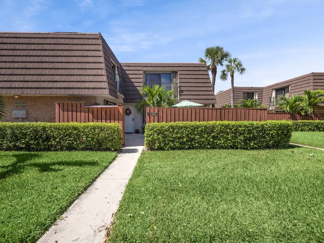 1206 12th Ct, Jupiter, FL 33477 - view of front of house featuring mansard roof and brick siding
