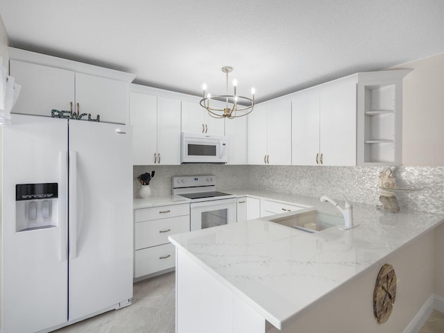1206 12th Ct, Jupiter, FL 33477 - kitchen with white appliances, a peninsula, a chandelier, white cabinets, and open shelves