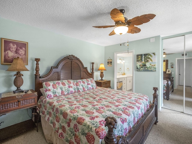 1206 12th Ct, Jupiter, FL 33477 - bedroom featuring carpet floors, a closet, a textured ceiling, ceiling fan, and connected bathroom