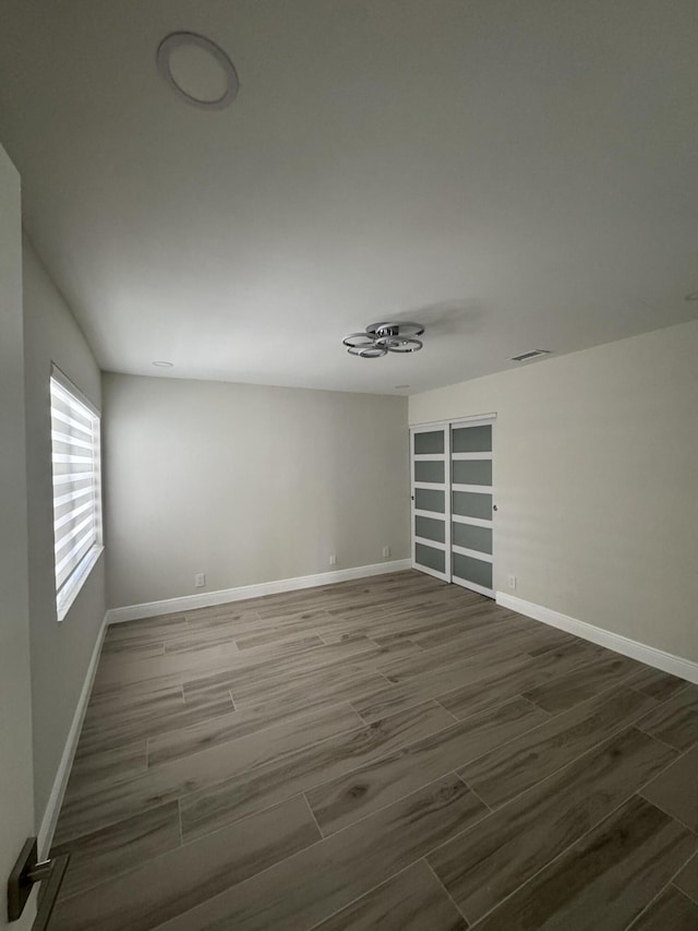 8711 Eagle Run Dr, Boca Raton, FL 33434 - empty room with wood tiled floors and baseboards
