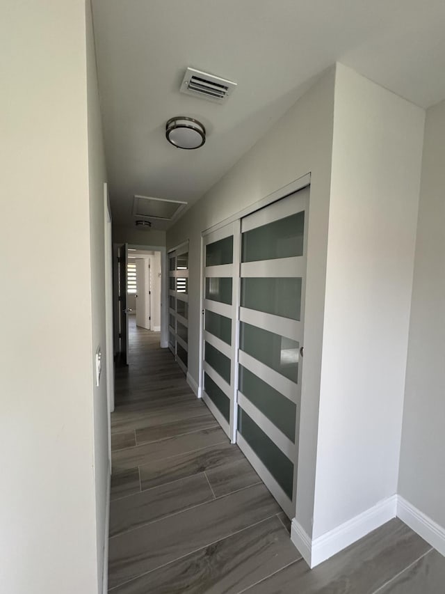 8711 Eagle Run Dr, Boca Raton, FL 33434 - hallway featuring dark wood-style flooring and attic access