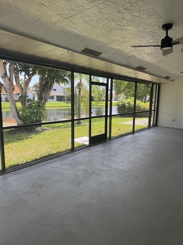 8711 Eagle Run Dr, Boca Raton, FL 33434 - unfurnished sunroom featuring a water view, ceiling fan, and plenty of natural light