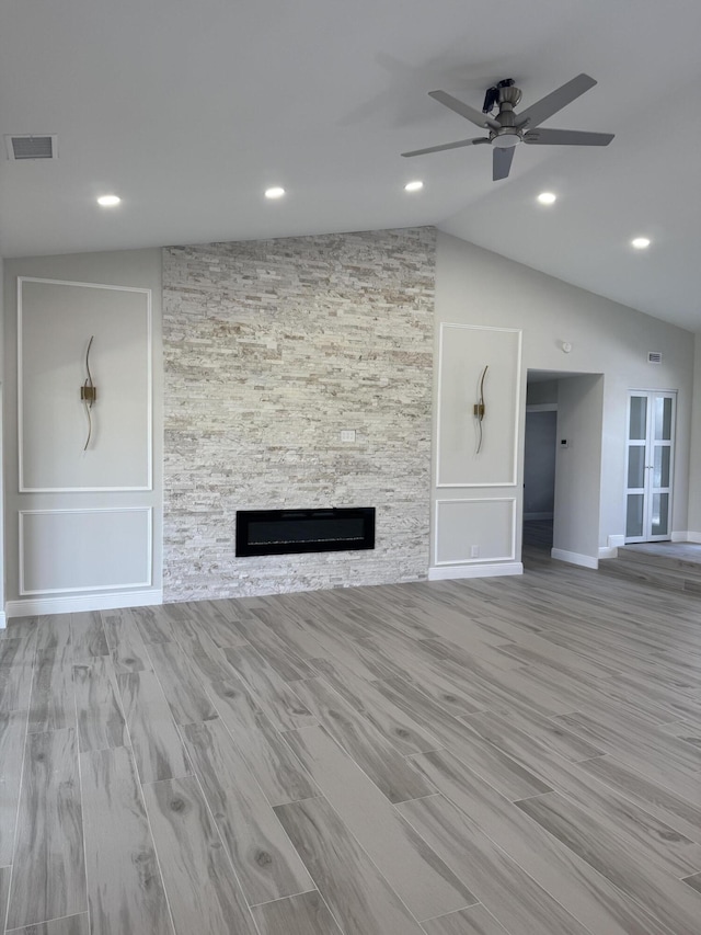 8711 Eagle Run Dr, Boca Raton, FL 33434 - unfurnished living room featuring a fireplace, a ceiling fan, vaulted ceiling, wood finished floors, and recessed lighting