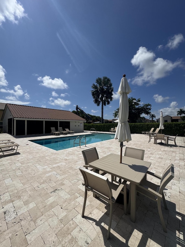 8711 Eagle Run Dr, Boca Raton, FL 33434 - community pool featuring a patio area and outdoor dining space