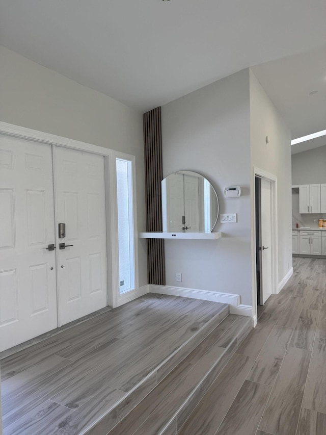 8711 Eagle Run Dr, Boca Raton, FL 33434 - foyer featuring light wood-type flooring and baseboards