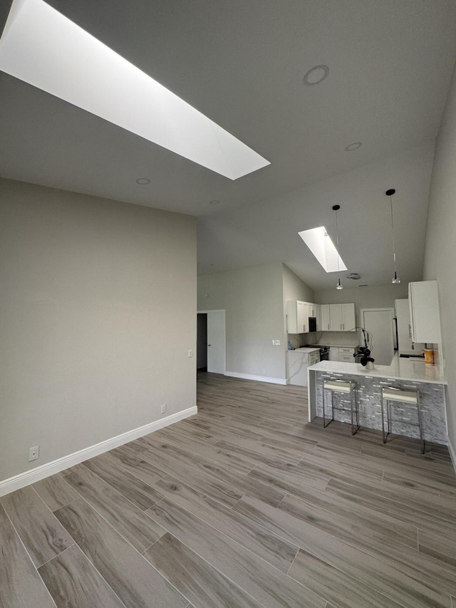 8711 Eagle Run Dr, Boca Raton, FL 33434 - living room with a skylight, light wood finished floors, and high vaulted ceiling