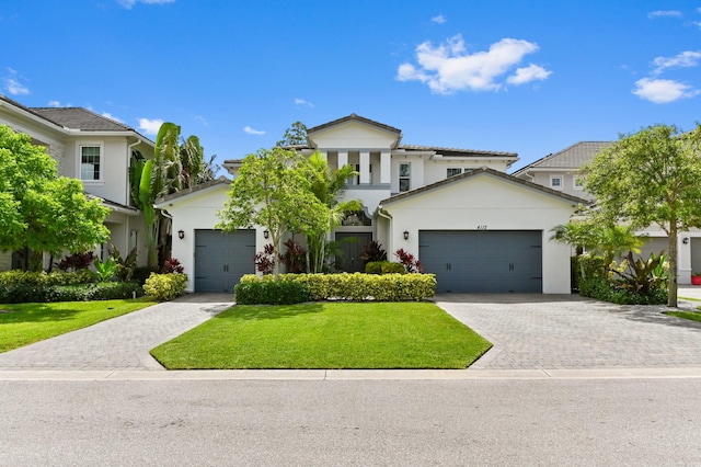4112 Italia Way, Lake Worth, FL 33467 - view of front of property with decorative driveway, stucco siding, a front yard, and an attached garage