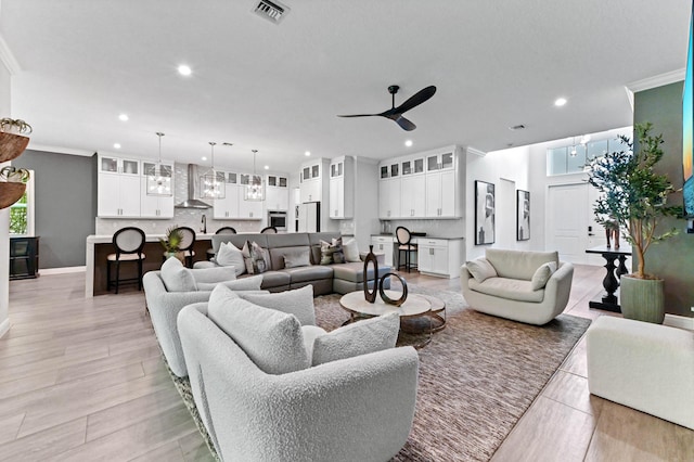 4112 Italia Way, Lake Worth, FL 33467 - living room featuring a ceiling fan, recessed lighting, crown molding, and light wood-type flooring