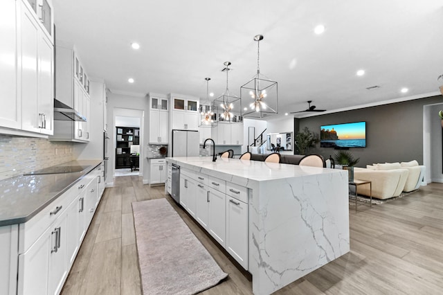 4112 Italia Way, Lake Worth, FL 33467 - kitchen with recessed lighting, a spacious island, a chandelier, decorative backsplash, and stainless steel appliances