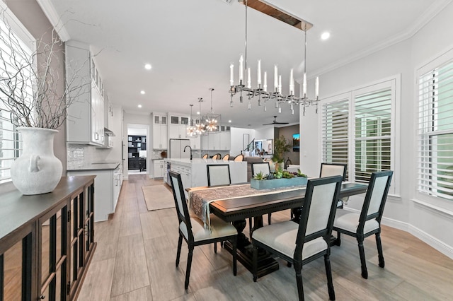4112 Italia Way, Lake Worth, FL 33467 - dining room with crown molding, healthy amount of natural light, a chandelier, light wood finished floors, and recessed lighting