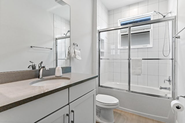 4112 Italia Way, Lake Worth, FL 33467 - bathroom featuring vanity, enclosed tub / shower combo, and wood finished floors