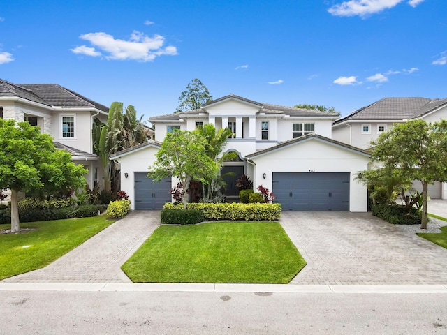 4112 Italia Way, Lake Worth, FL 33467 - view of front of home featuring decorative driveway, a front yard, stucco siding, and an attached garage