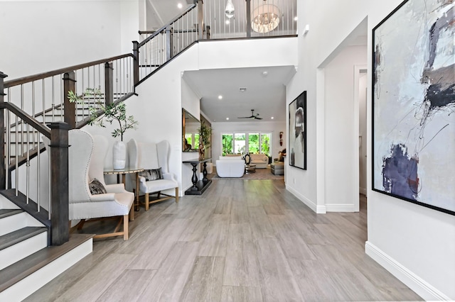 4112 Italia Way, Lake Worth, FL 33467 - foyer entrance with stairs, wood finished floors, a ceiling fan, a high ceiling, and recessed lighting