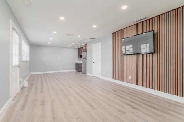 2058 SE Watercrest St, Port Saint Lucie, FL 34984 - unfurnished living room with recessed lighting and light wood-style flooring