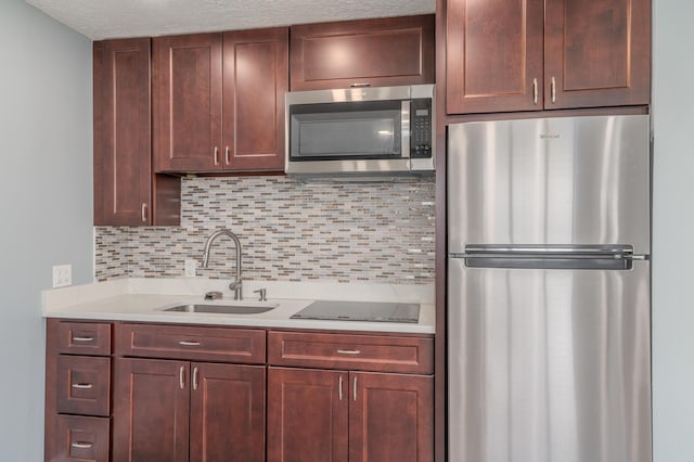 2058 SE Watercrest St, Port Saint Lucie, FL 34984 - kitchen featuring appliances with stainless steel finishes, light countertops, backsplash, and a textured ceiling