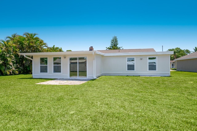 2058 SE Watercrest St, Port Saint Lucie, FL 34984 - back of house with a lawn, a patio, and a chimney