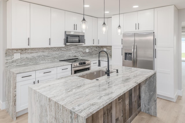 2058 SE Watercrest St, Port Saint Lucie, FL 34984 - kitchen featuring stainless steel appliances, light wood-style flooring, backsplash, white cabinetry, and recessed lighting