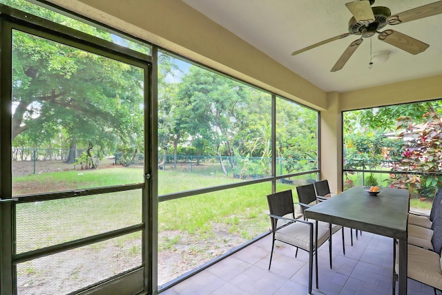 1466 Artimino Ln, Boynton Beach, FL 33436 - sunroom featuring ceiling fan, outdoor dining area, and view of scattered trees