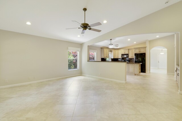 1466 Artimino Ln, Boynton Beach, FL 33436 - unfurnished living room featuring arched walkways, lofted ceiling, a ceiling fan, light tile patterned floors, and recessed lighting