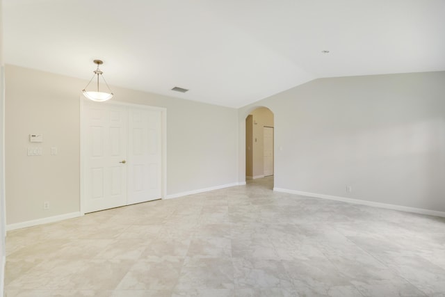1466 Artimino Ln, Boynton Beach, FL 33436 - spare room featuring arched walkways and vaulted ceiling
