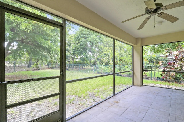 1466 Artimino Ln, Boynton Beach, FL 33436 - unfurnished sunroom featuring ceiling fan and view of scattered trees