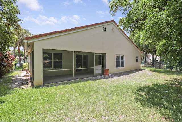 1466 Artimino Ln, Boynton Beach, FL 33436 - back of house with stucco siding, a ceiling fan, and a sunroom