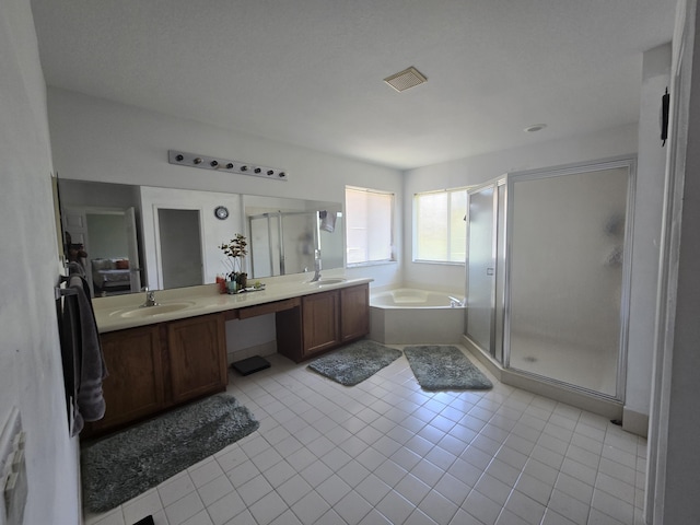2137 Little Torch St, Riviera Beach, FL 33407 - bathroom featuring a bath, double vanity, a stall shower, and tile patterned flooring