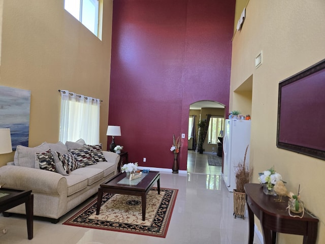 2137 Little Torch St, Riviera Beach, FL 33407 - living area with a high ceiling, arched walkways, plenty of natural light, and tile patterned floors