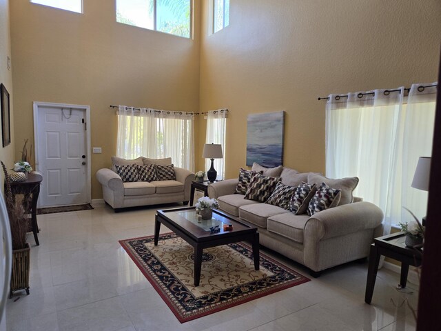 2137 Little Torch St, Riviera Beach, FL 33407 - living room featuring healthy amount of natural light, a high ceiling, and light tile patterned floors