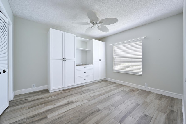 166 Bayberry Cir, Jupiter, FL 33458 - unfurnished bedroom featuring a textured ceiling, light wood-style flooring, ceiling fan, and a closet