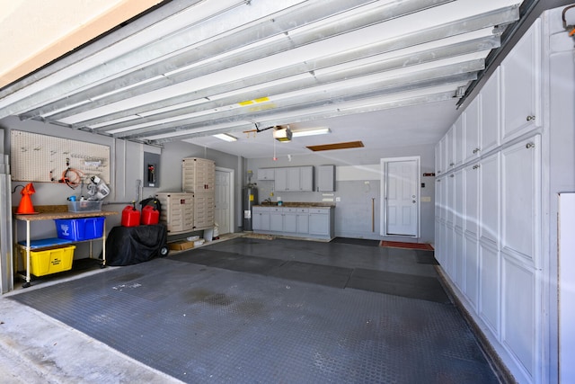 166 Bayberry Cir, Jupiter, FL 33458 - garage featuring electric water heater and a garage door opener