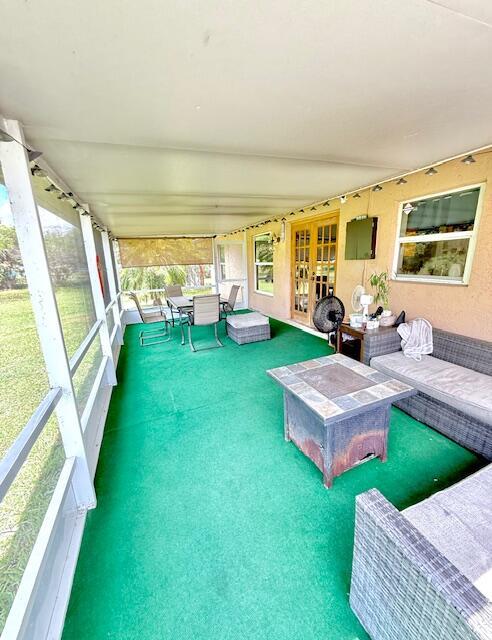 15252 74th St Unit N, The Acreage, FL 33470 - sunroom featuring french doors and an outdoor living space