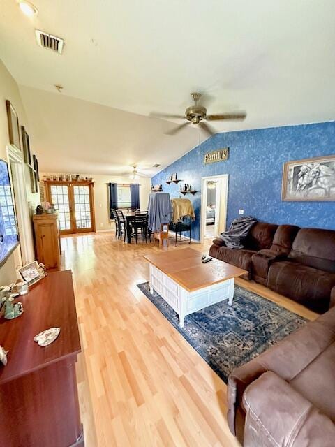 15252 74th St Unit N, The Acreage, FL 33470 - living room featuring vaulted ceiling, ceiling fan, light wood-style flooring, french doors, and wallpapered walls