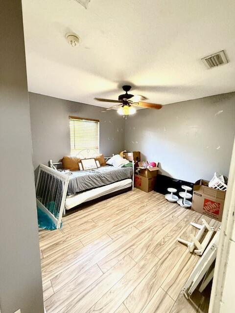 15252 74th St Unit N, The Acreage, FL 33470 - bedroom featuring wood finished floors and a ceiling fan