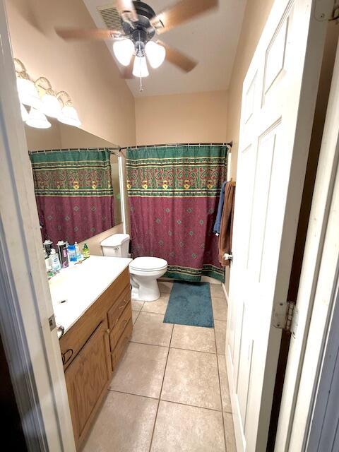 15252 74th St Unit N, The Acreage, FL 33470 - full bath featuring vanity, tile patterned floors, ceiling fan, and curtained shower