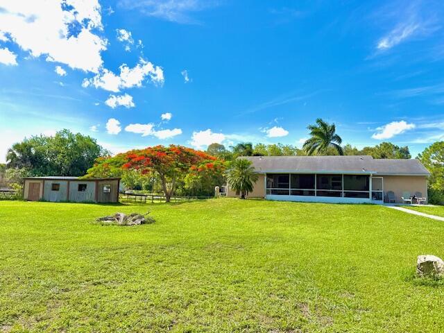 15252 74th St Unit N, The Acreage, FL 33470 - view of grassy yard featuring a sunroom
