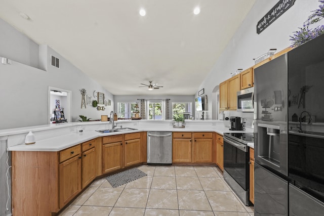 421 NW Cornell Ave, Port Saint Lucie, FL 34983 - kitchen with appliances with stainless steel finishes, lofted ceiling, a ceiling fan, a peninsula, and light countertops