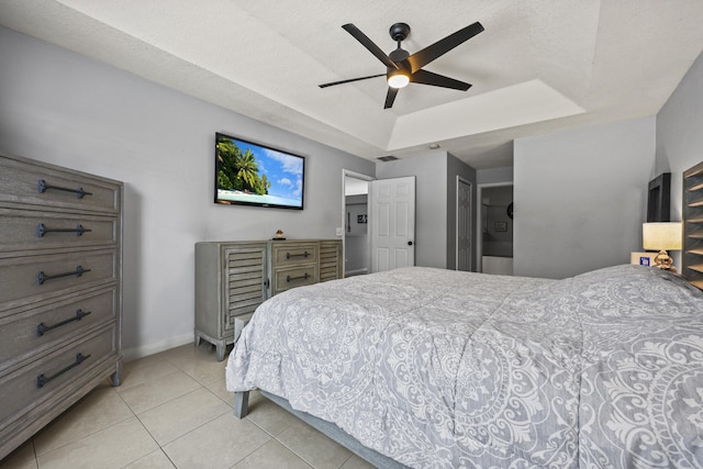 421 NW Cornell Ave, Port Saint Lucie, FL 34983 - bedroom with a raised ceiling, light tile patterned flooring, and a ceiling fan
