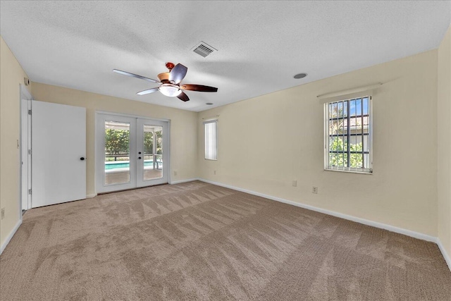 11061 NW 45th St, Coral Springs, FL 33065 - unfurnished room featuring french doors, carpet flooring, plenty of natural light, and a textured ceiling