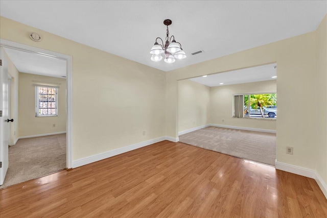 11061 NW 45th St, Coral Springs, FL 33065 - spare room featuring a chandelier, plenty of natural light, light wood finished floors, and a smoke detector