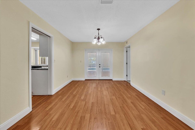 11061 NW 45th St, Coral Springs, FL 33065 - unfurnished dining area with a chandelier, light wood-style floors, and french doors