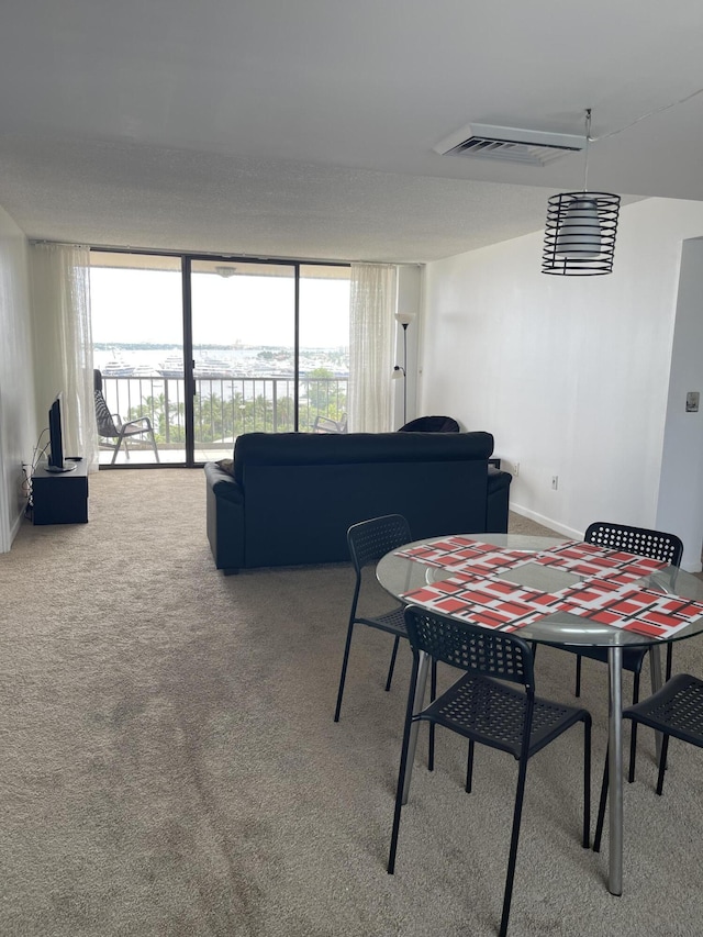 5200 N Flagler Dr Unit 1106, West Palm Beach, FL 33407 - dining space with carpet floors and floor to ceiling windows