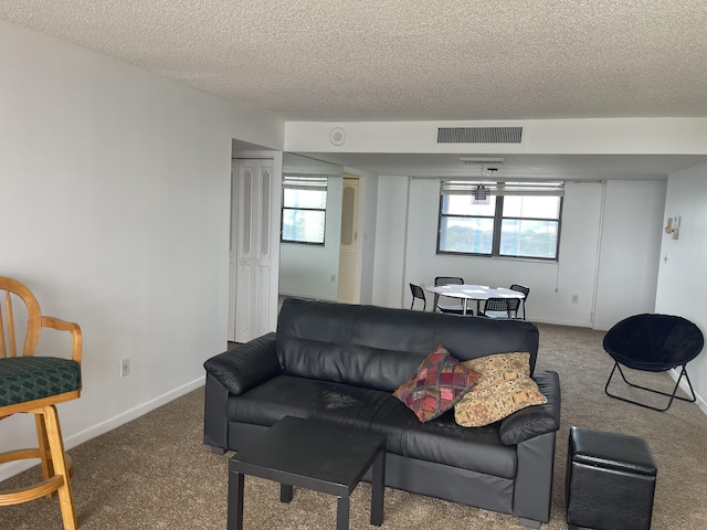 5200 N Flagler Dr Unit 1106, West Palm Beach, FL 33407 - carpeted living area featuring a textured ceiling and baseboards