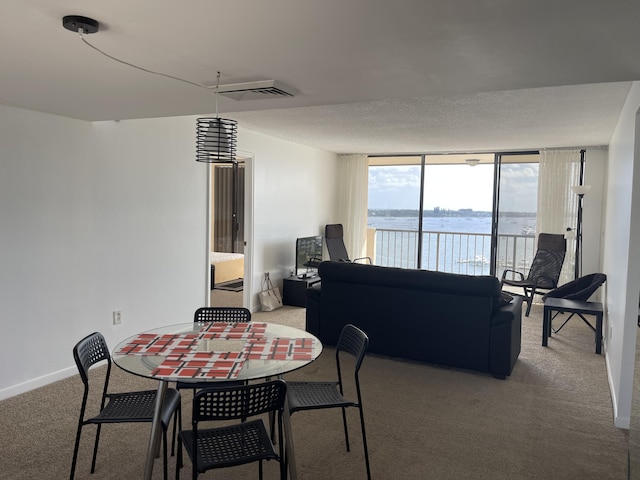 5200 N Flagler Dr Unit 1106, West Palm Beach, FL 33407 - dining space with carpet floors and expansive windows
