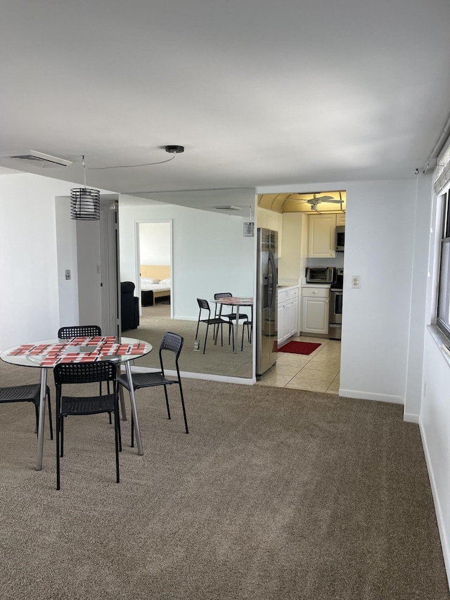 5200 N Flagler Dr Unit 1106, West Palm Beach, FL 33407 - dining space with light carpet and a ceiling fan