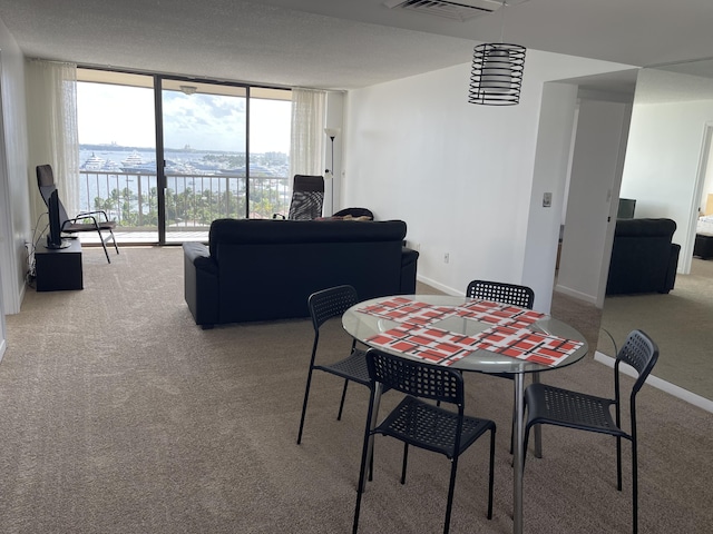 5200 N Flagler Dr Unit 1106, West Palm Beach, FL 33407 - dining room with light colored carpet and a wall of windows