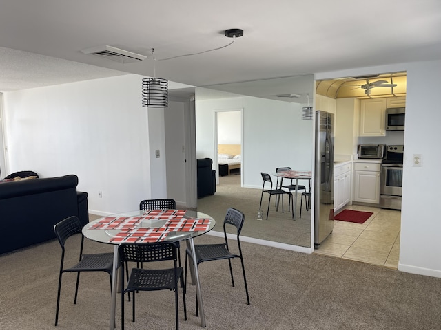 5200 N Flagler Dr Unit 1106, West Palm Beach, FL 33407 - dining space featuring light carpet, ceiling fan, and light tile patterned flooring