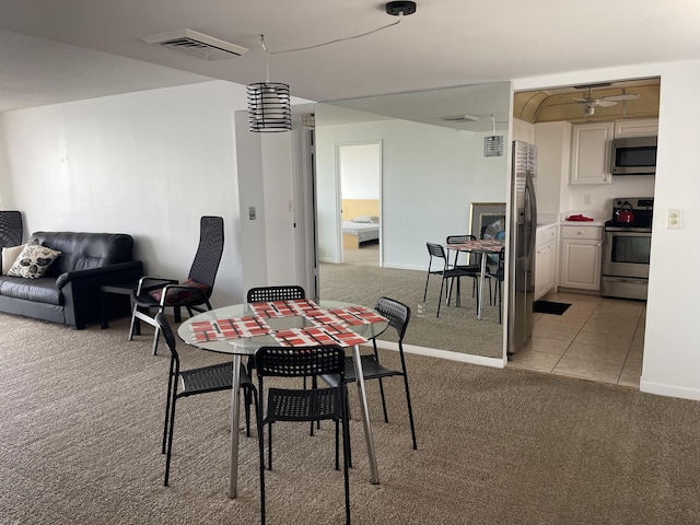 5200 N Flagler Dr Unit 1106, West Palm Beach, FL 33407 - dining area with light carpet, ceiling fan, and light tile patterned floors